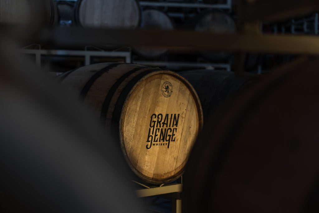 picture of a barrel of whisky with the name grain henge stenciled on it