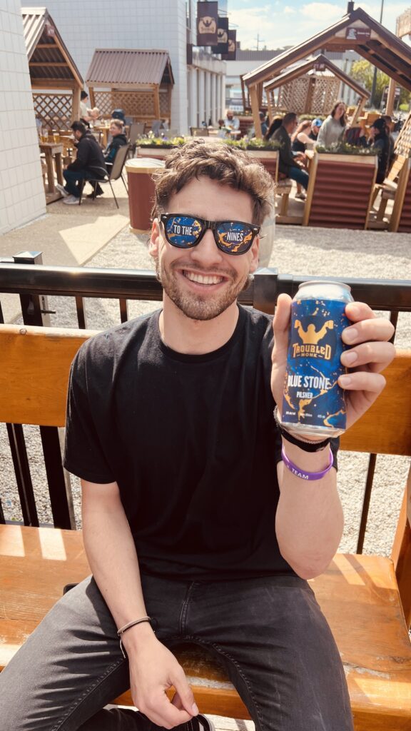 Guy smiling holding Blue Stone